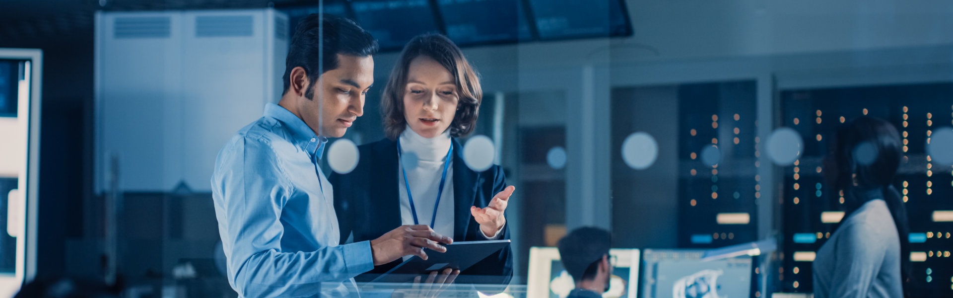 Man and woman discuss about something in the tablet