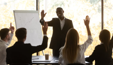 young business team raising hands