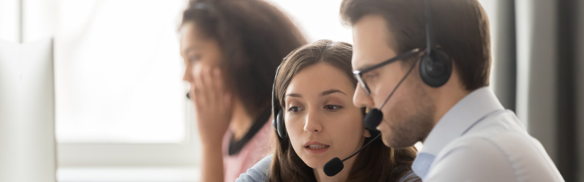 Woman discussing papers to a man.