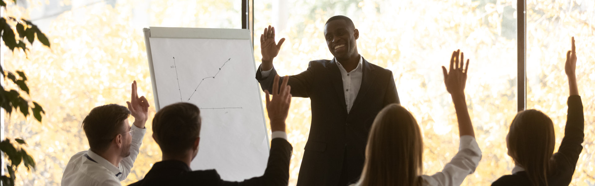 young business team raising hands